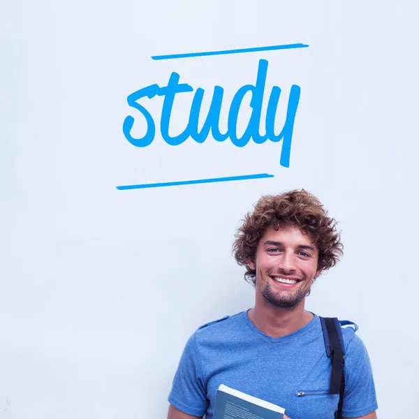 Study against happy student holding book