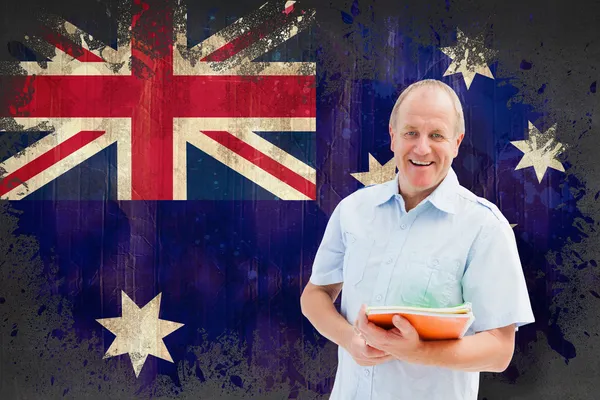 Student holding notebooks against australia flag