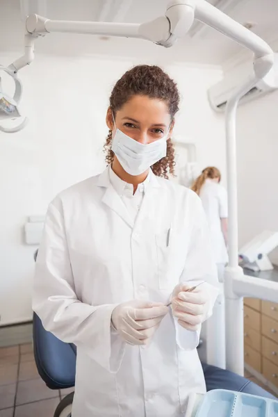 Dentist examining her tools on a tray