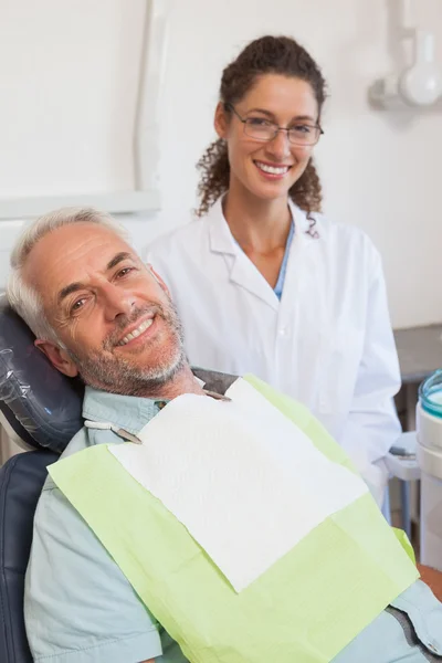 Patient and dentist smiling