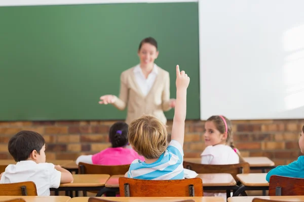 Pupils listening to their teacher at chalkboard