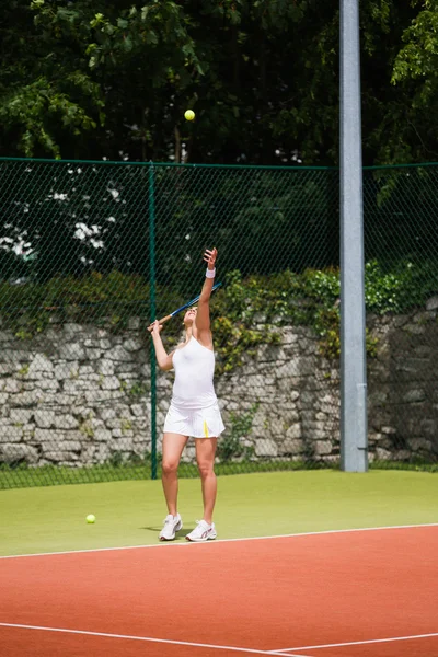 Pretty tennis player serving the ball