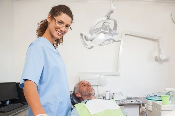 Dentist with patient in the chair