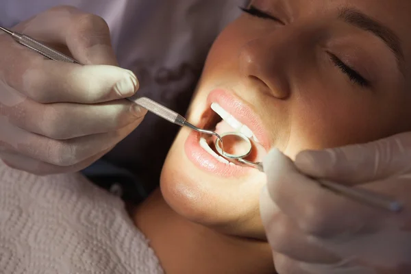 Dentist examining a patients teeth