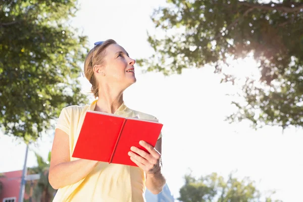 Blonde woman using her guide book