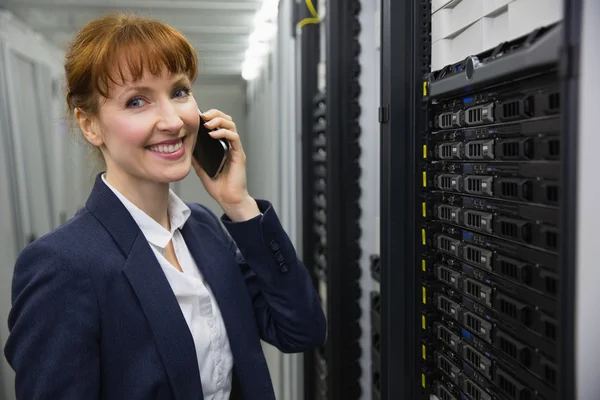 Smiling technician talking on phone