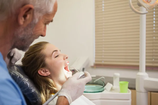 Dentist examining a patients teeth