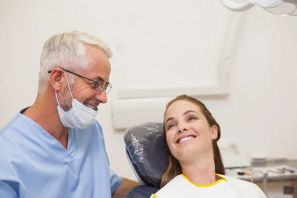 Dentist and patient smiling at each other
