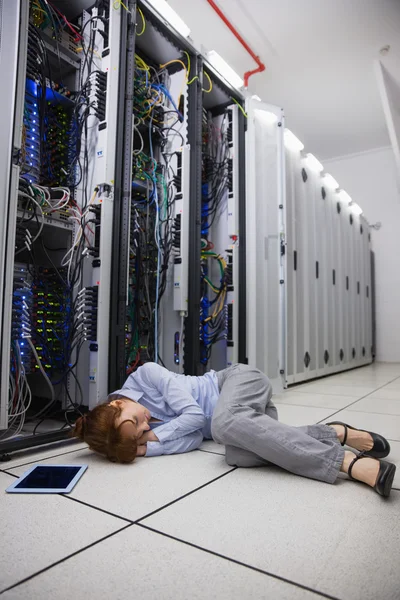 Exhausted technician sleeping on the floor