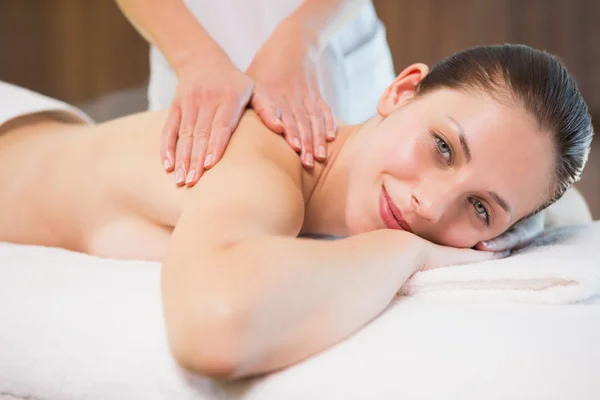 Attractive woman receiving back massage at spa center