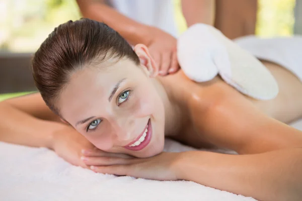 Attractive woman receiving back massage at spa center