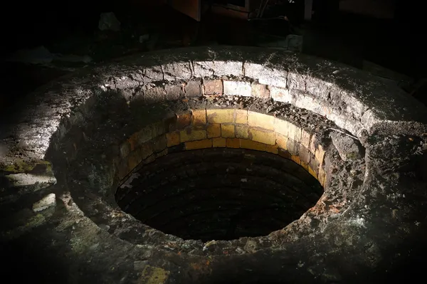 Ominous brick well with mysterious lighting