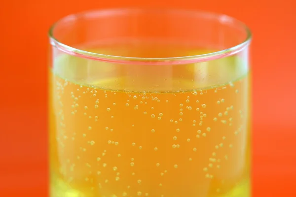 A glass of orange flavored calcium effervescent tablet