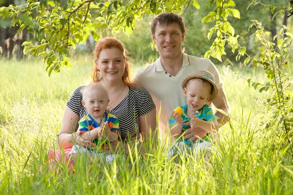 Big happy family - mother, father and children grass