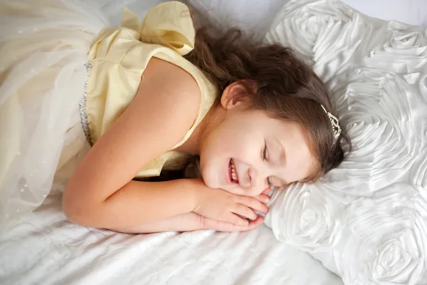Pretty little girl sleeping and smiling in her sleep.