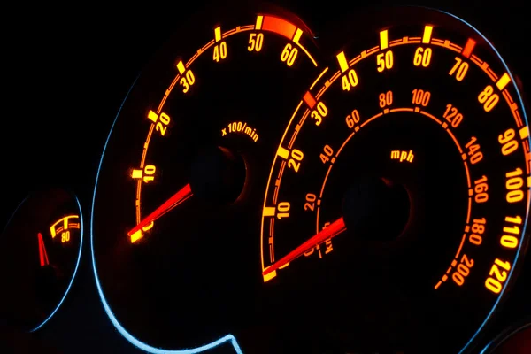 Backlit car dashboard dials glowing at night — Stock Photo #21731115