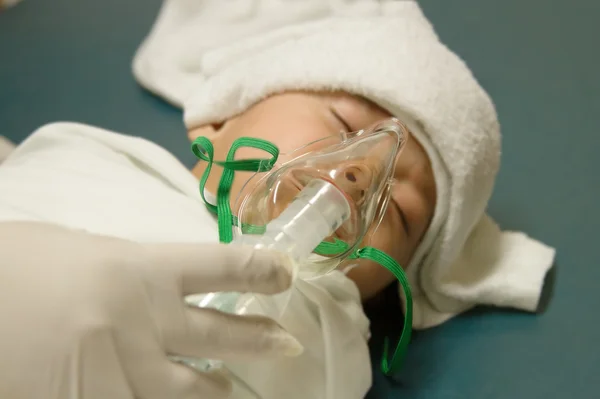 Sick baby wear oxygen mask of the inhaler