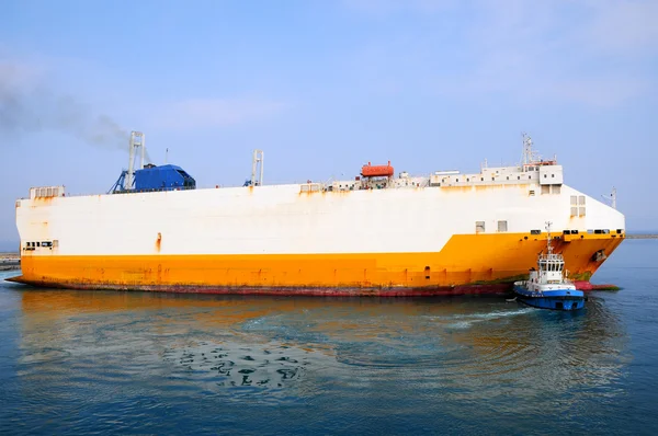 Tugboat towing a ship