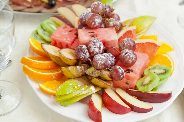 Elegant table setting in restaurant with dishes full of food for celebration