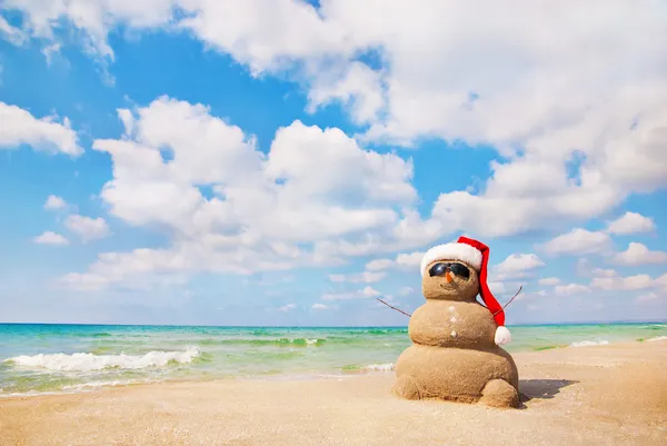 Sand snowman in santa hat. Holiday concept can be used for New Y