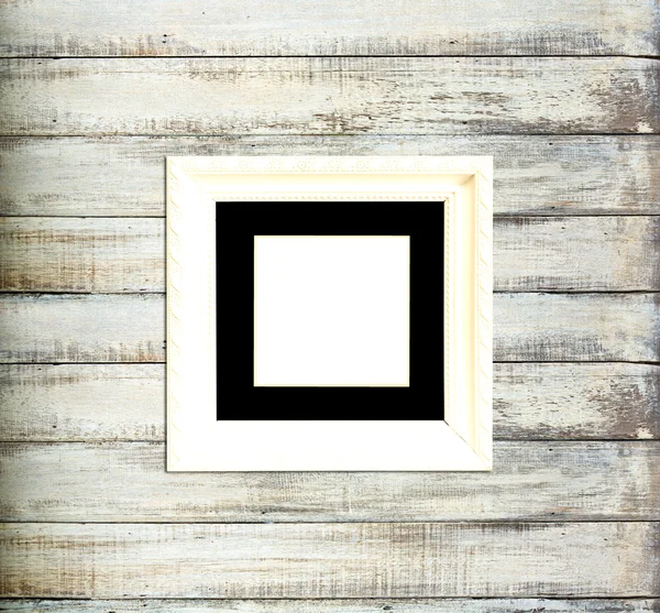 White Vintage picture frame on old wood background — Stock Photo #12111000