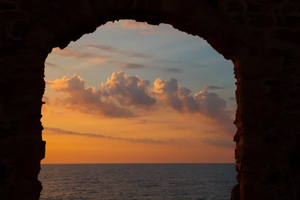 Stone arch, Mediterranean sea and evening sky
