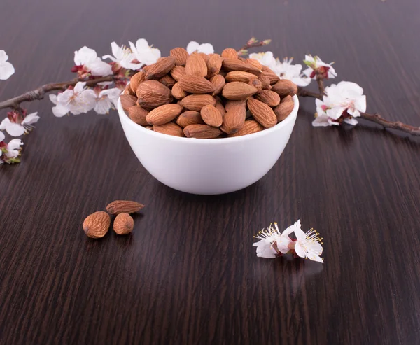 Roasted almonds in white porcelain bowl