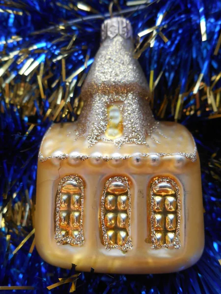 Christmas and New Year tree decorations gold house on a dark blue background