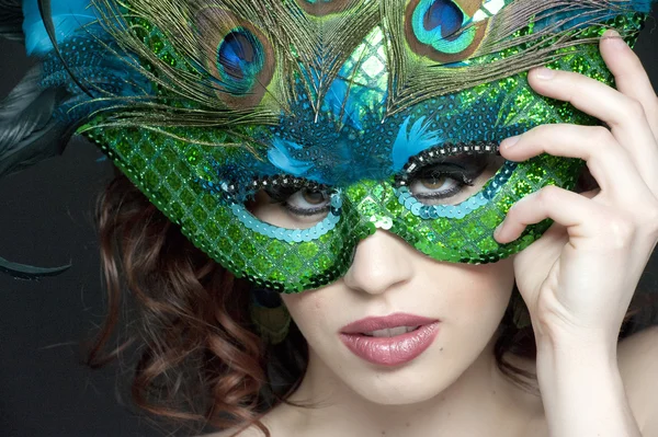 Attractive woman holding the mask