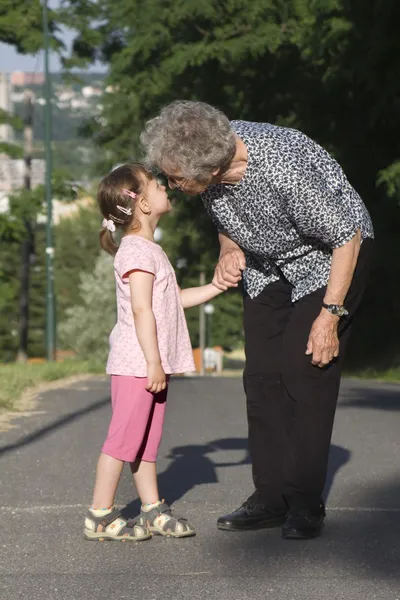 Grandmother and grandchild by the walk