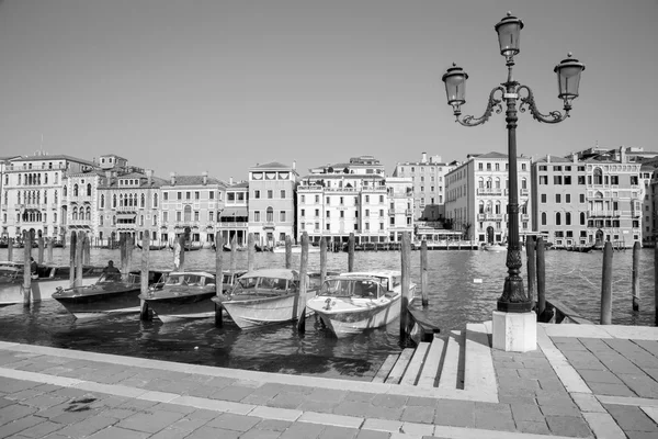VENICE, ITALY - MARCH 13, 2014: Canal grande and boats for church Santa Maria della Salute.