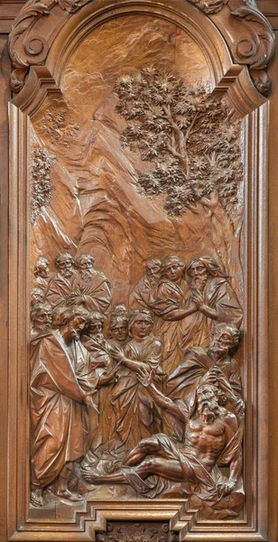 MECHELEN, BELGIUM - JUNE 14, 2014: The Miracle of Apostle John and Peter healing the lame carved relief by Ferdinand Wijnants in st. Johns church or Janskerk from begin of 20. cent.