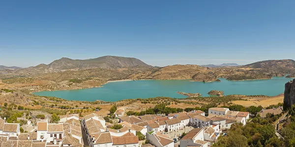 Panoramic landscape photo of Sierra de Grazalema national park. Old village with white houses. Pueblos blancos. Beautiful scenery. Blue sky. Malaga. Andalusia. Spain.