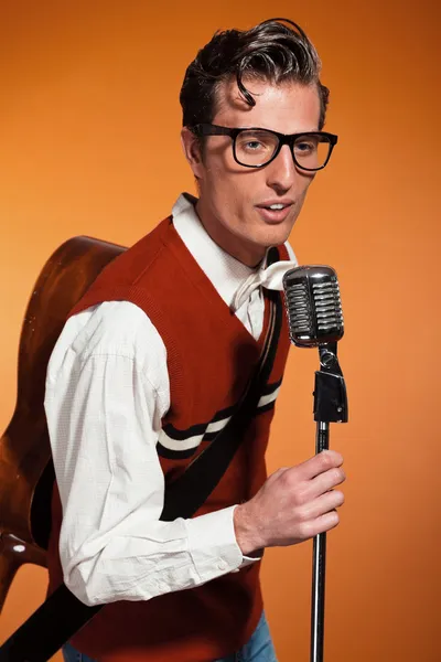 Retro fifties style rock and roll singer with vintage microphone