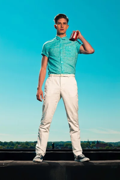 Vintage 50s summer fashion man in blue shirt listens to portable