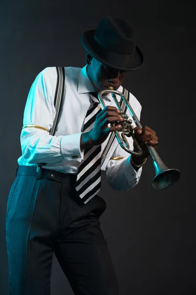Retro african american jazz musician playing on his trumpet. Wea