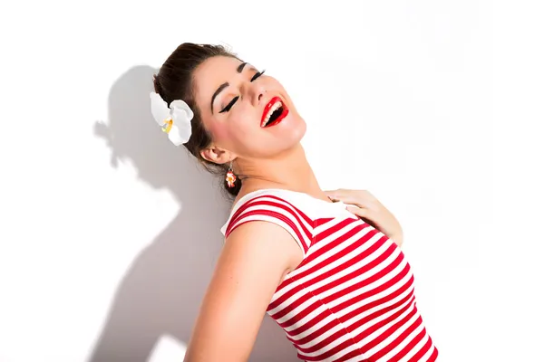 Sexy retro pin-up girl with red lipstick wearing red striped shi