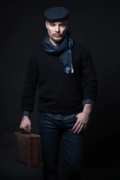 Man winter fashion. Wearing black sweater with scarf and cap. Ho
