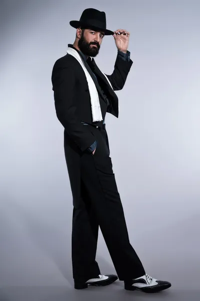 Retro hipster 1900 fashion man in suit with black hair and beard