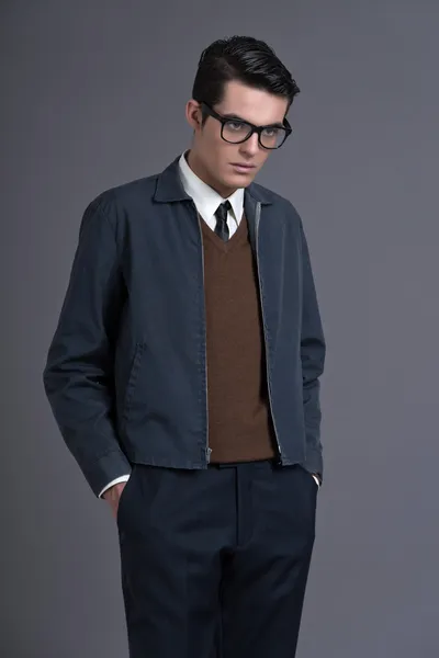 Retro fifties fashion man with dark grease hair. Wearing brown s
