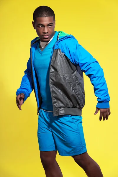 Athletic black man in sportswear fashion. Runner with jacket. In