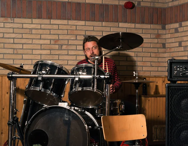 Energetic rock drummer in action. Long blonde hair. Jam session.