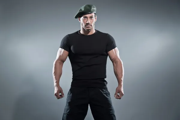 Commander muscled action hero man wearing black t-shirt and pant