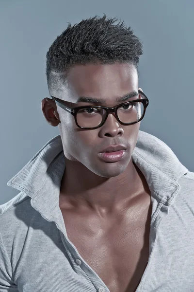 Black african man. Eyewear fashion. Studio shot against grey.