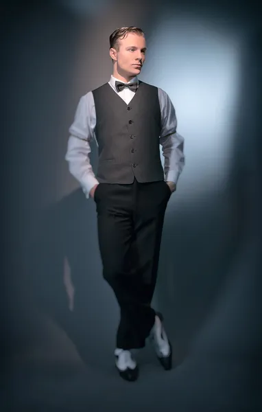 Retro classic business fashion man wearing grey gilet and bow ti
