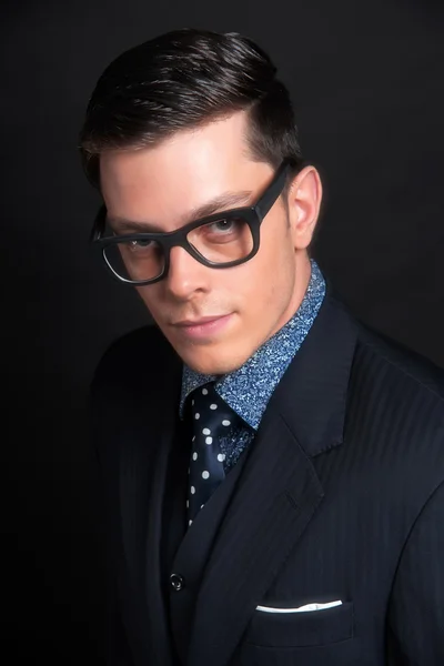 Stylish young business man wearing black retro glasses and dark
