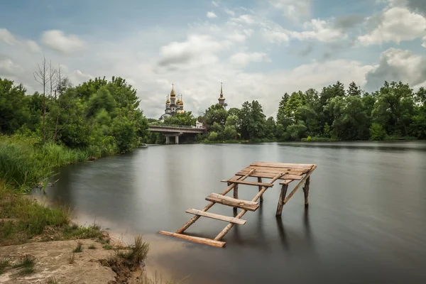 Minimalist landscape with bridge and church