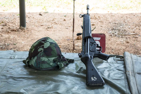 HK33 rifle with military helmet