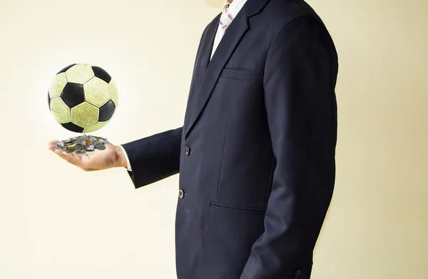 Businessman holding a soccer ball