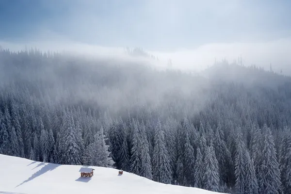 Winter mountain landscape with blue sky and white clouds